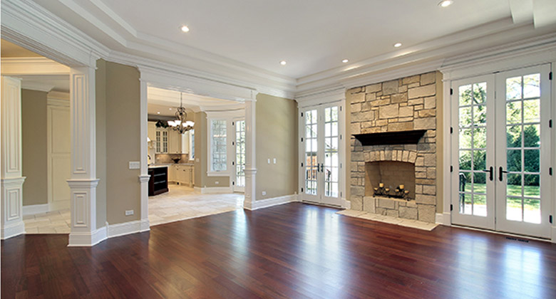hardwood flooring in an open living room complements the tile floor in the kitchen